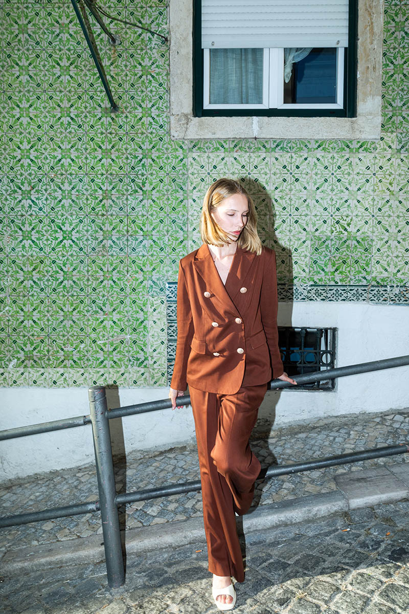 woman in red blazer & pants on the streets of lisbon