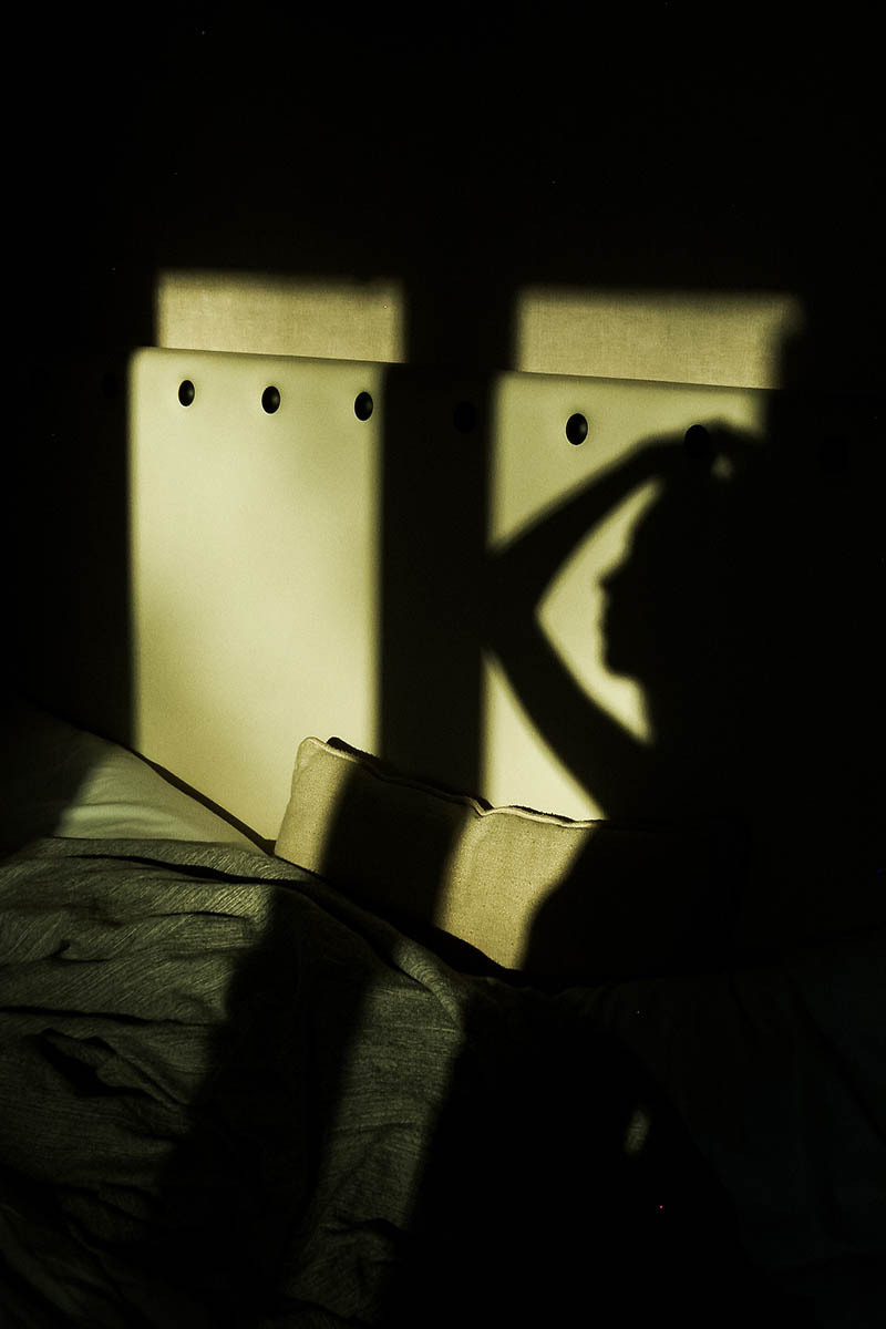 shadow play, woman standing infront of a window
