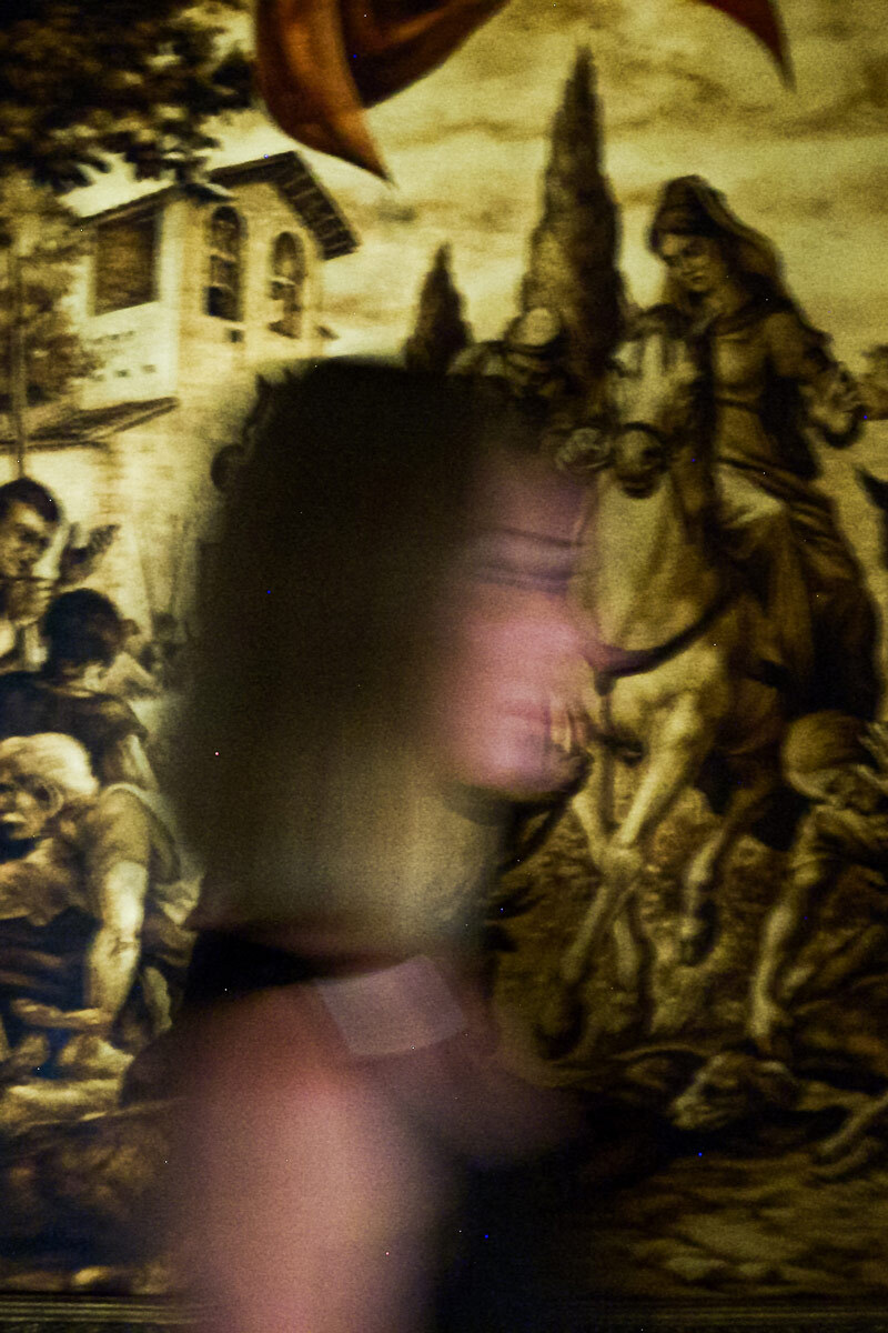 woman in front of a painting