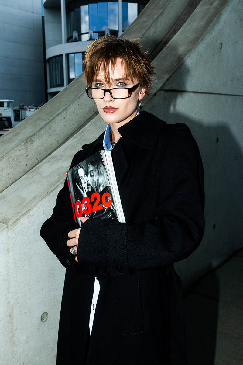 woman with a magazine, wearing glasses
