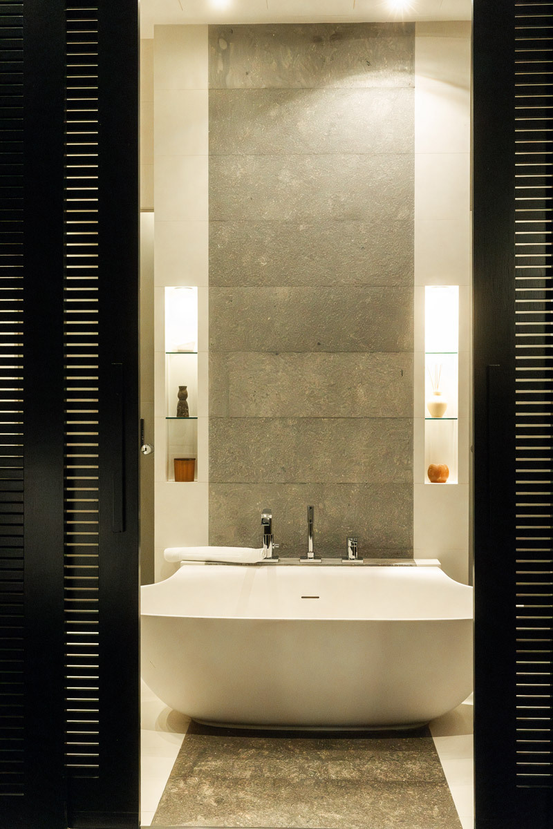 photo of white bathtub, through a door