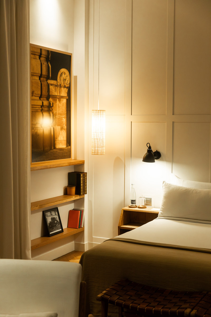 bed with a book shelf next to it
