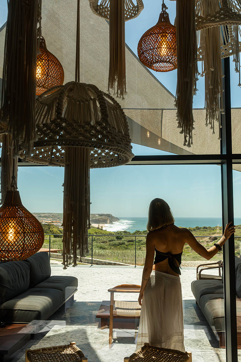 photo of woman standing in front of a big window