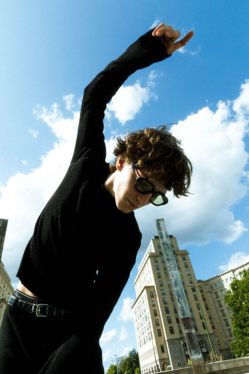 man captured between two buildings, in movement