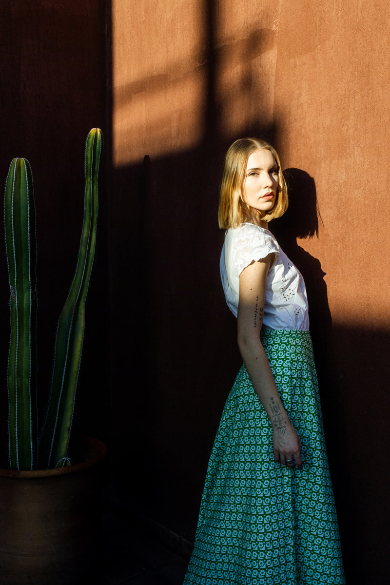 girl standing in front of a wall