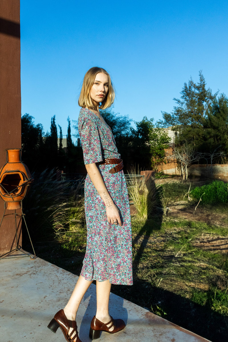 girl wearing dress standing in a park