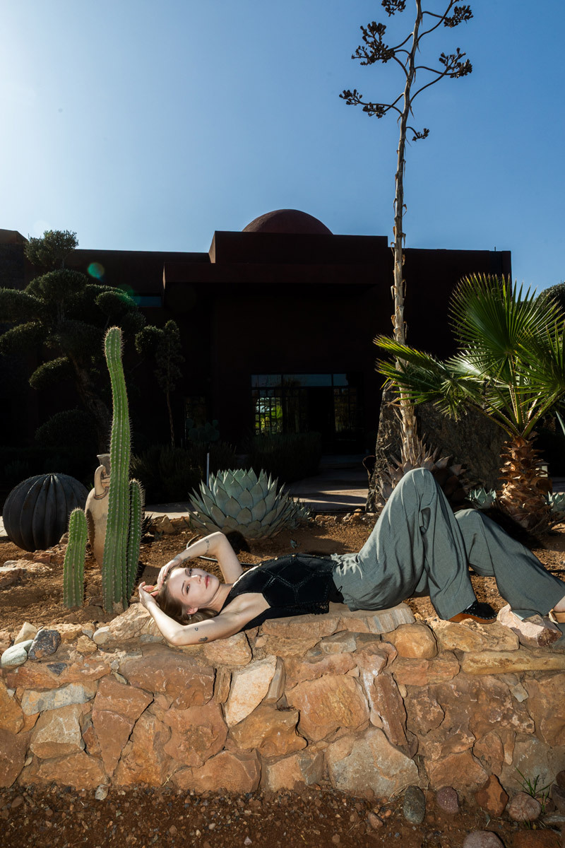 girl laying on a stone wall