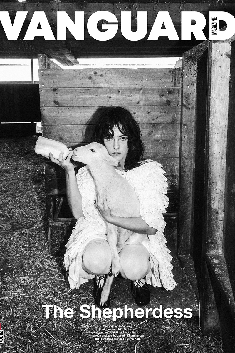 magazine cover, girl feeding a sheep