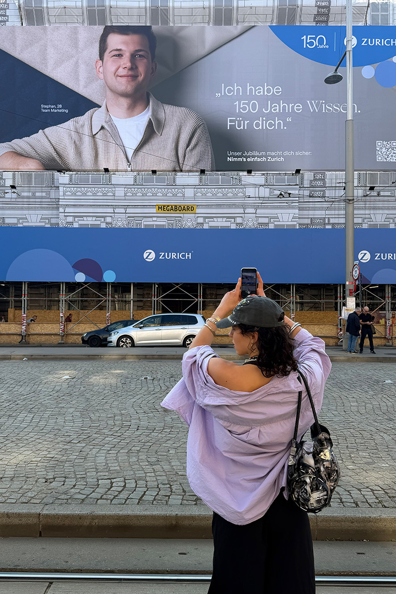 woman standing in front of a billboard